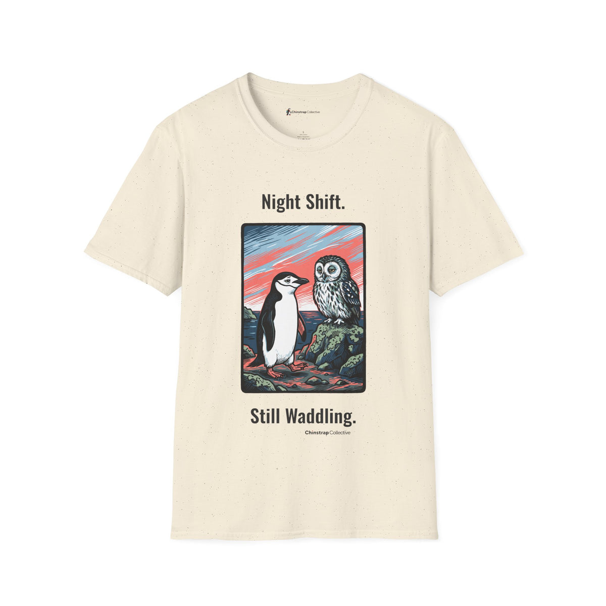 Still Waddling penguin T-shirt in Natural: The art shows the chinstrap penguin on the rocky shore at dawn, trading a…