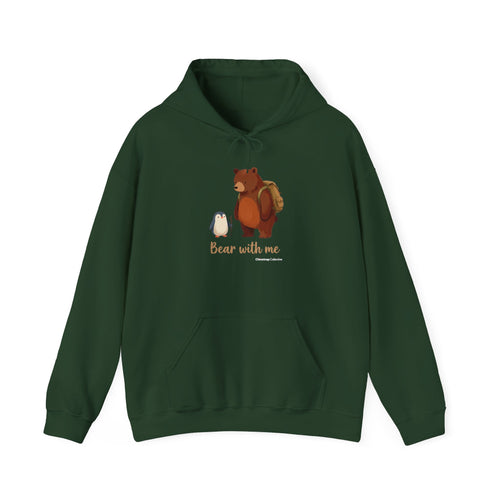 Bear With Me penguin hoodie in Forest Green: A small penguin with a walking stick stands beside a big brown bear wearing…