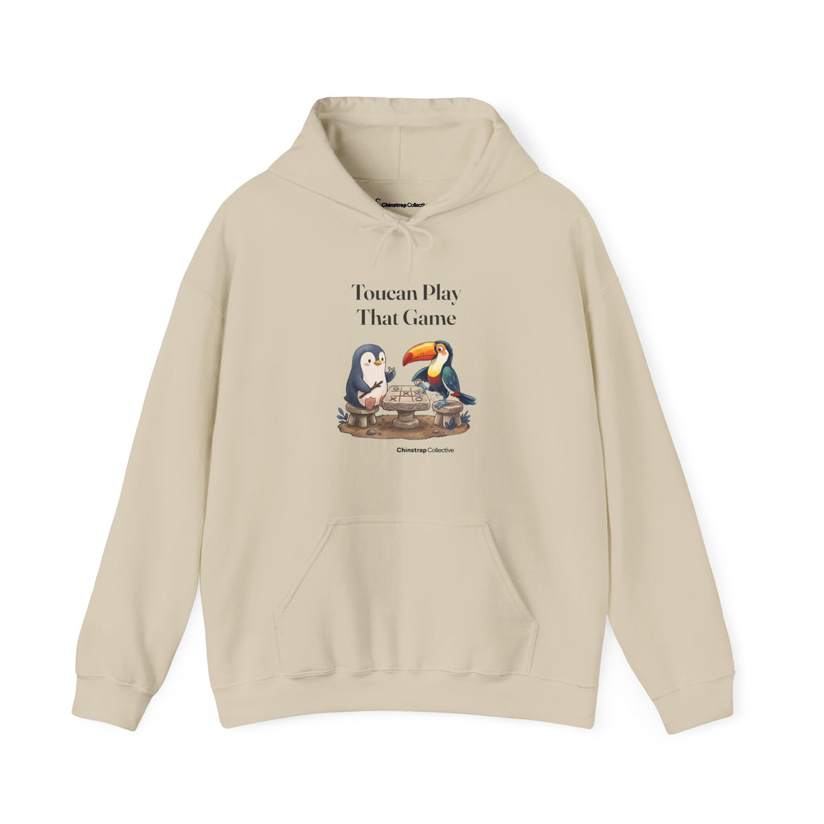Toucan Play That Game penguin hoodie in Sand: The chinstrap penguin sits across from a toucan at a stone tic-tac-toe…
