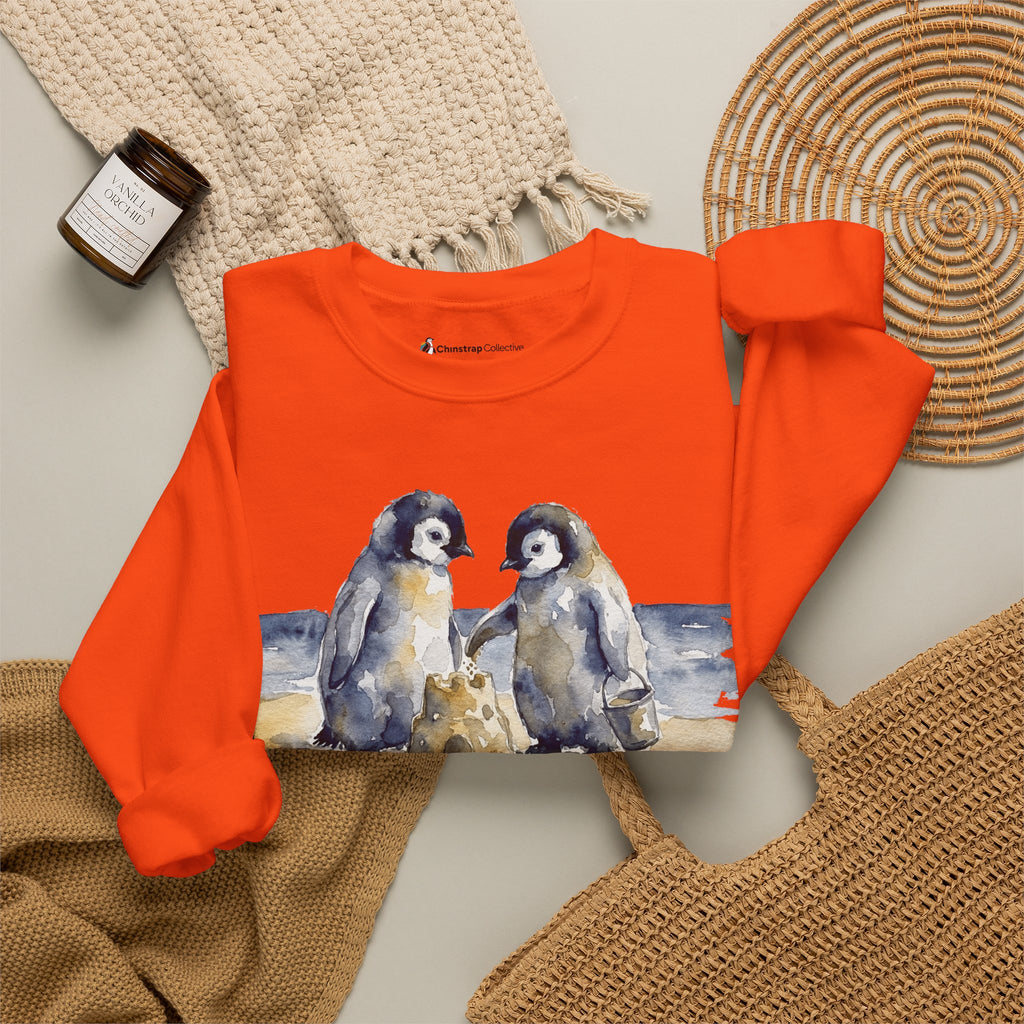 The Sandcastle Penguin Chicks sweatshirt in Orange, folded