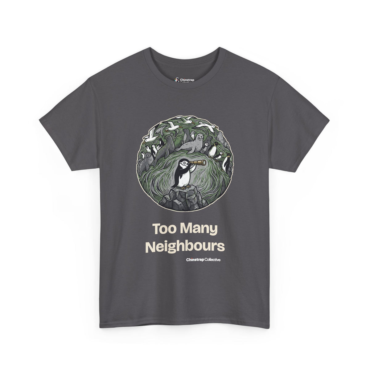 Too Many Neighbours penguin T-shirt in Charcoal: In a round, engraving-style scene of greens and greys, the penguin peers…