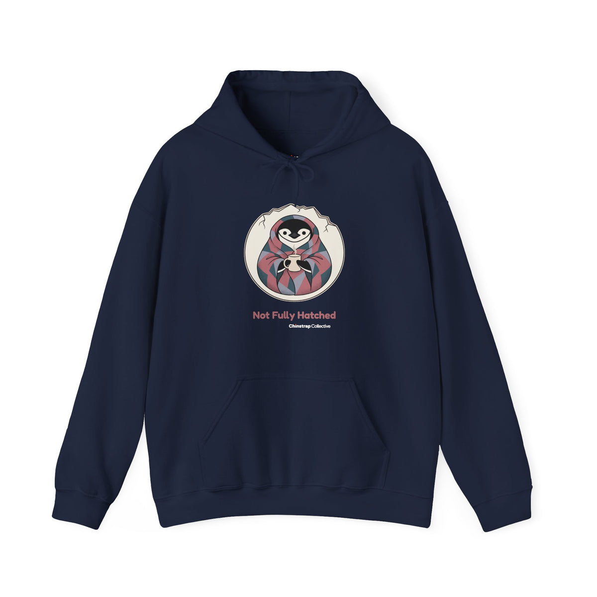 Not Fully Hatched penguin hoodie in Navy: Wrapped in a round eggshell white blanket with a jagged cracked rim, the…