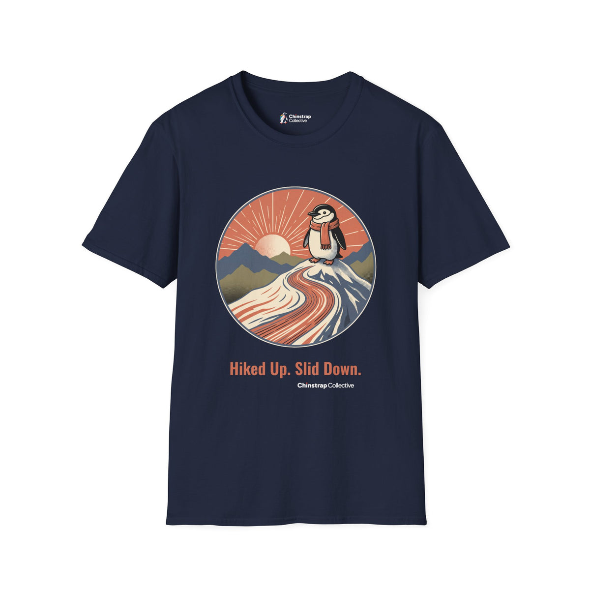 Hiked Up penguin T-shirt in Navy: Under a rising sun with fanned rays, the penguin in an orange scarf stands