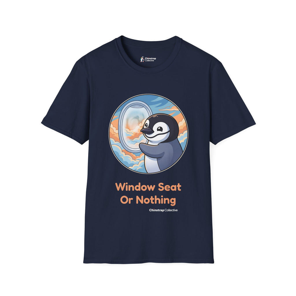 Window Seat penguin T-shirt in Navy: A cartoon chinstrap penguin beside a round airplane window full of peach and blue…
