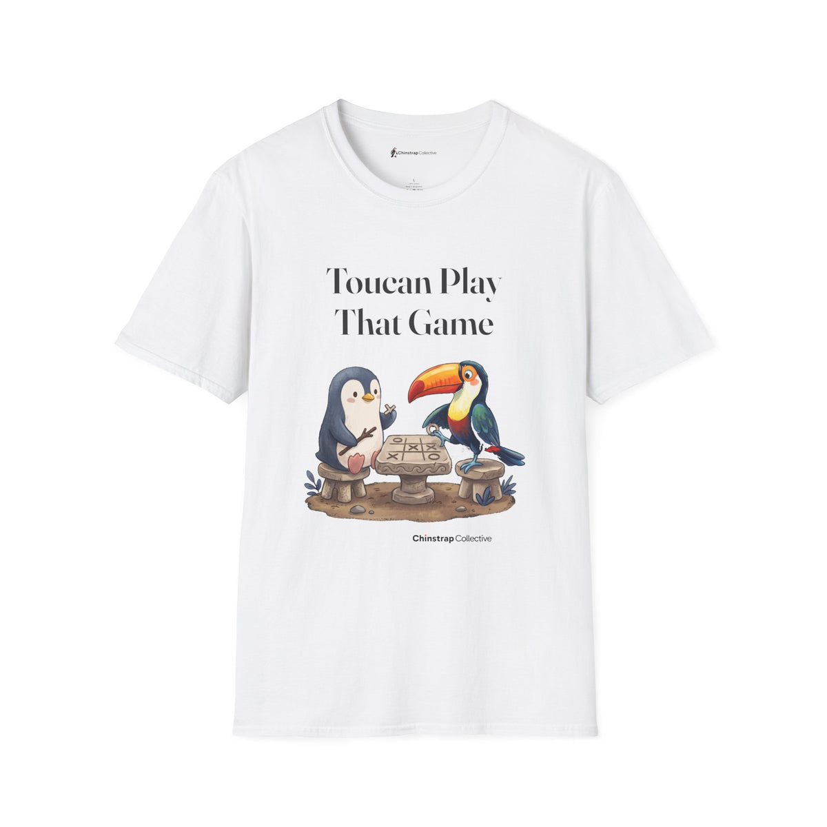 Toucan Play That Game penguin T-shirt in White: The penguin and a bright toucan sit on stone stools at a stone…