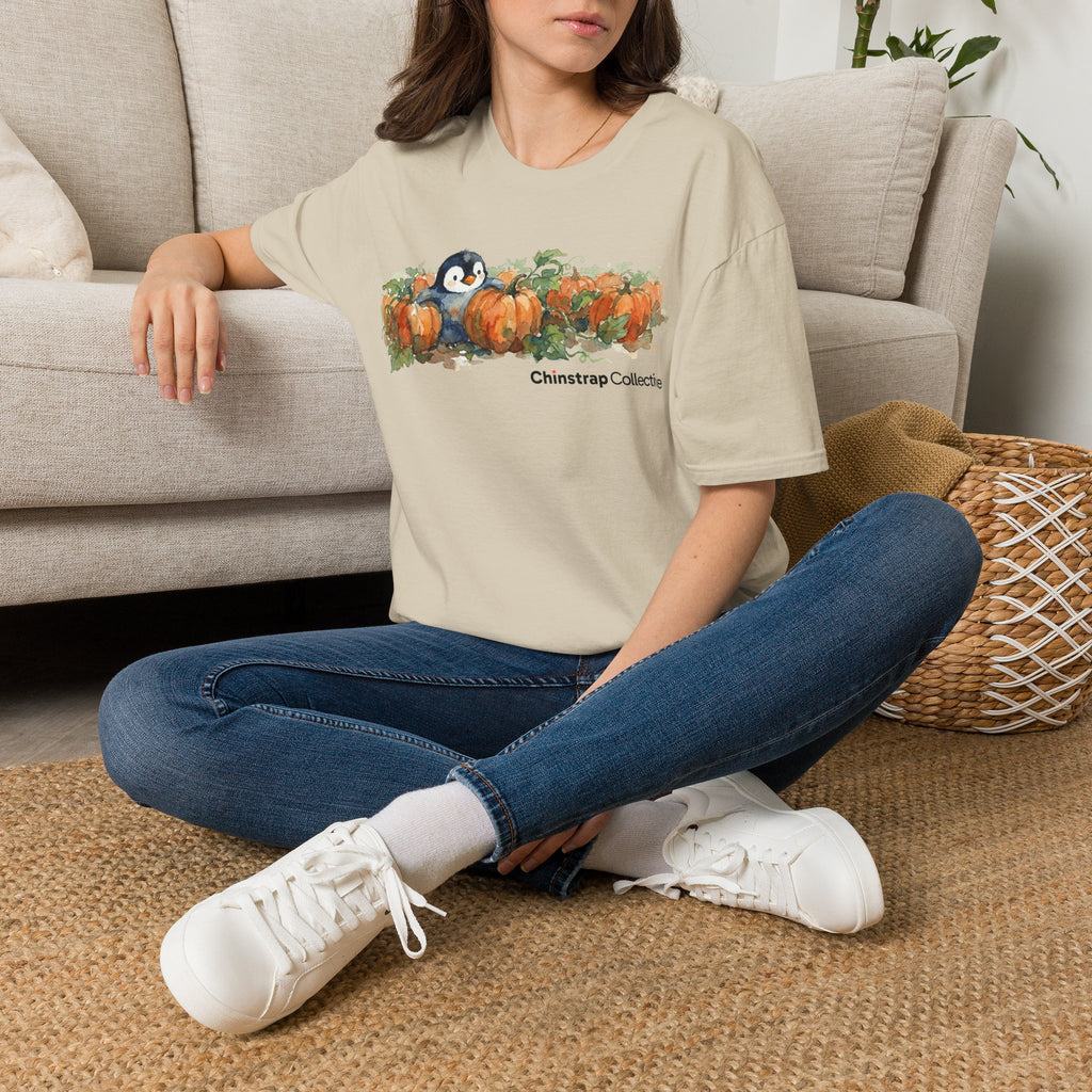 The Penguin Pumpkin Patch T-shirt in Sand, worn outdoors