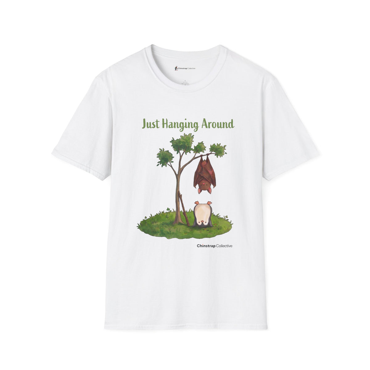 Just Hanging Around penguin T-shirt in White: A brown bat hangs upside down from a leafy tree while, on the grass below,…