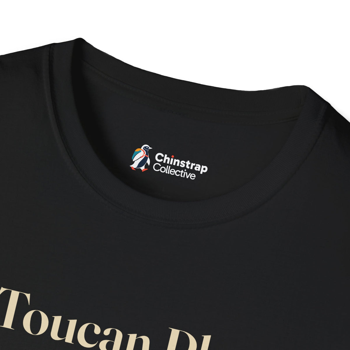 The Chinstrap Collective neck label on the Toucan Play That Game T-shirt in Black