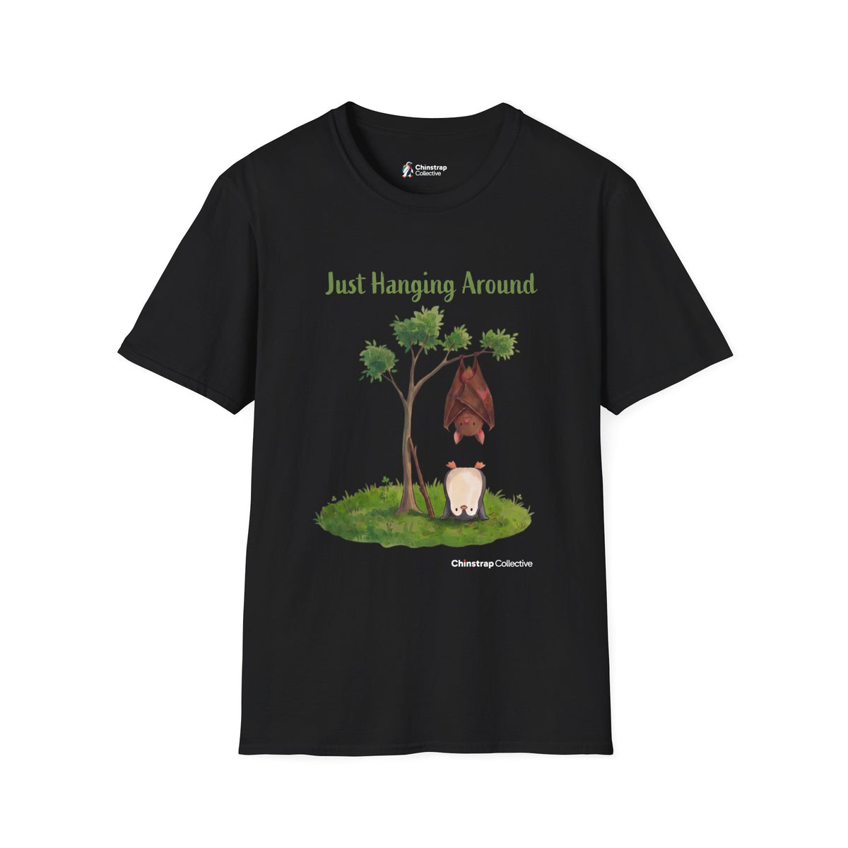 Just Hanging Around penguin T-shirt in Black: A brown bat hangs upside down from a leafy tree while, on the grass below,…