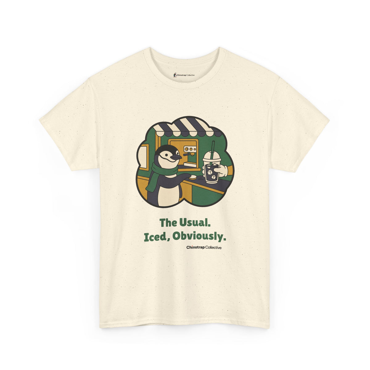 The Usual penguin T-shirt in Natural: Inside a green and gold sticker-style frame, the penguin in a green scarf slides a…