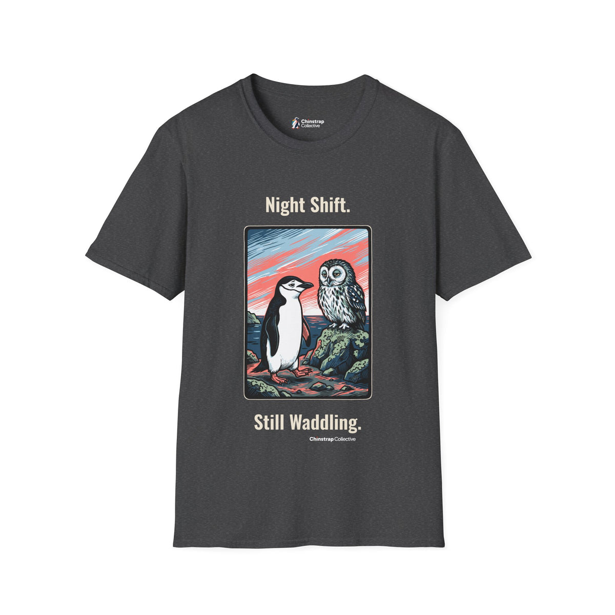 Still Waddling penguin T-shirt in Dark Heather: The art shows the chinstrap penguin on the rocky shore at dawn, trading a…