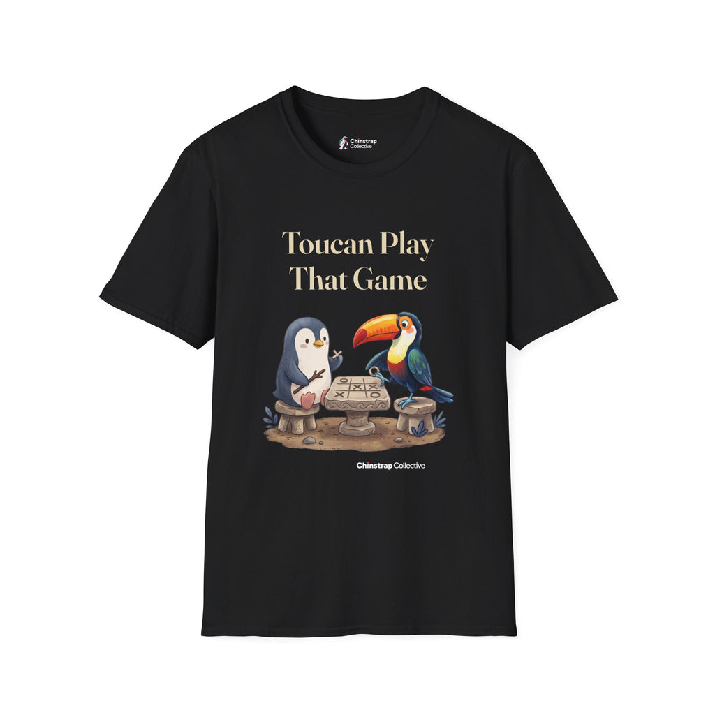 Toucan Play That Game penguin T-shirt in Black: The penguin and a bright toucan sit on stone stools at a stone…