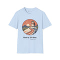 Hiked Up penguin T-shirt in Light Blue: Under a rising sun with fanned rays, the penguin in an orange scarf stands