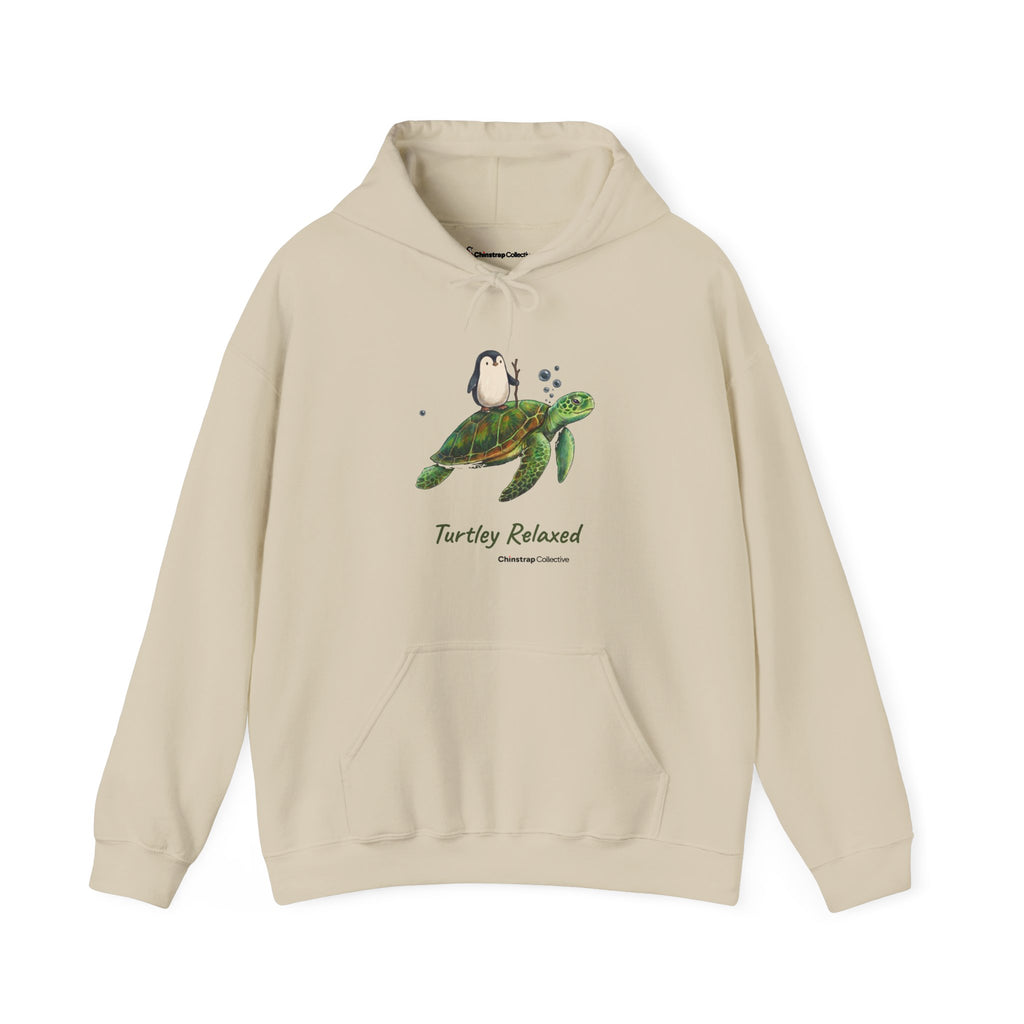 Turtley Relaxed penguin hoodie in Sand: The drawing shows the penguin, walking stick in flipper, riding on the back of a…