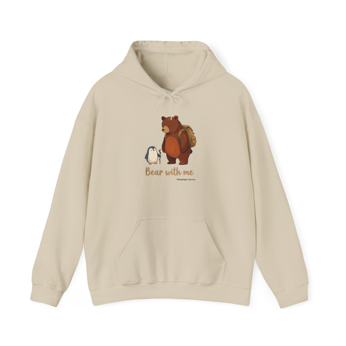 Bear With Me penguin hoodie in Sand: A small penguin with a walking stick stands beside a big brown bear wearing a hiking…